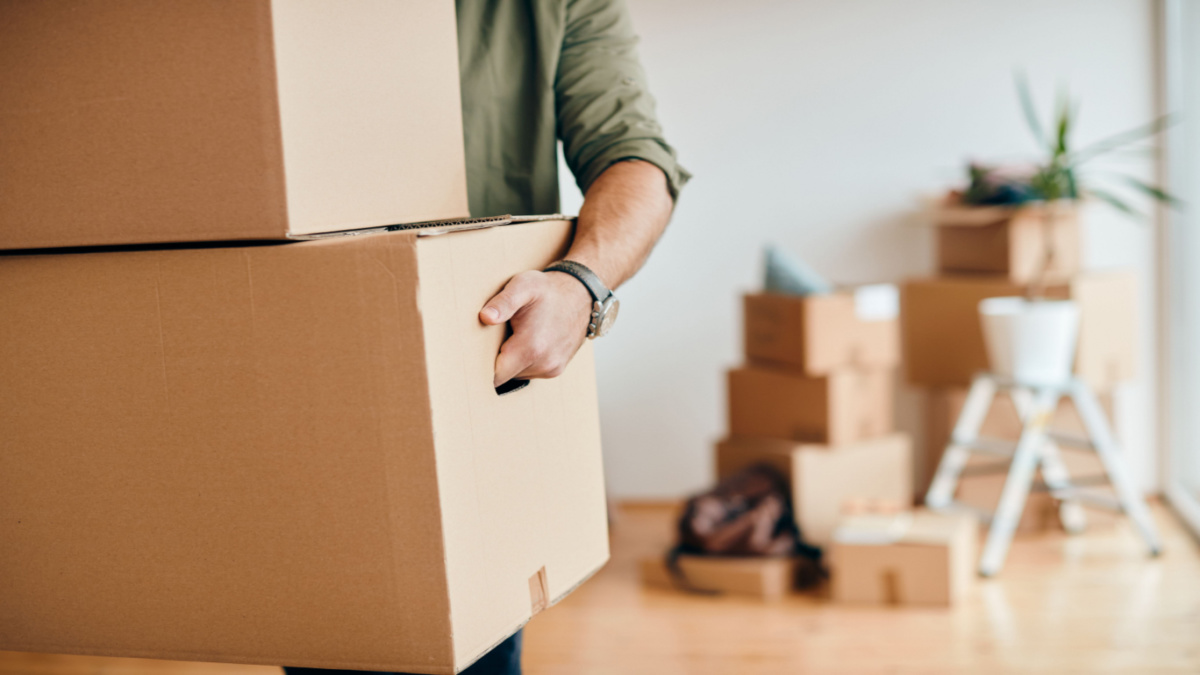 Man carrying boxes to move out of his house